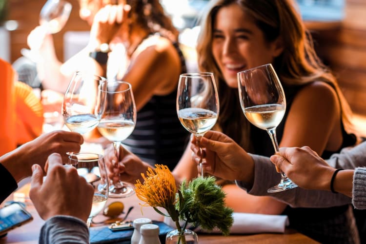 a group of friends enjoying a glass of white wine