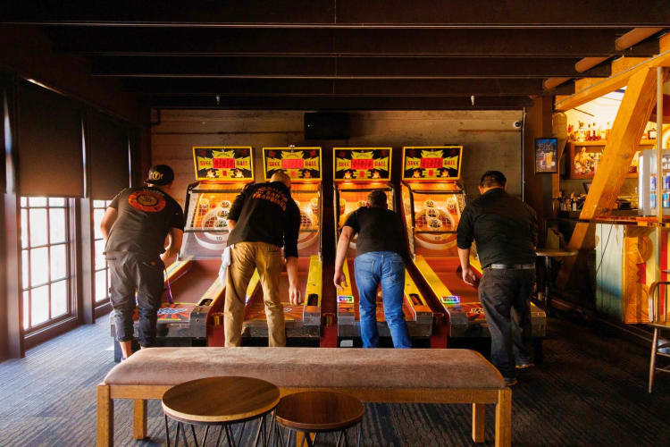 Friends playing at a retro arcade 