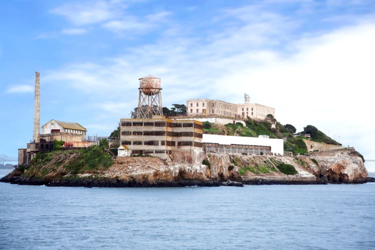 An island with a prison on it under a blue sky