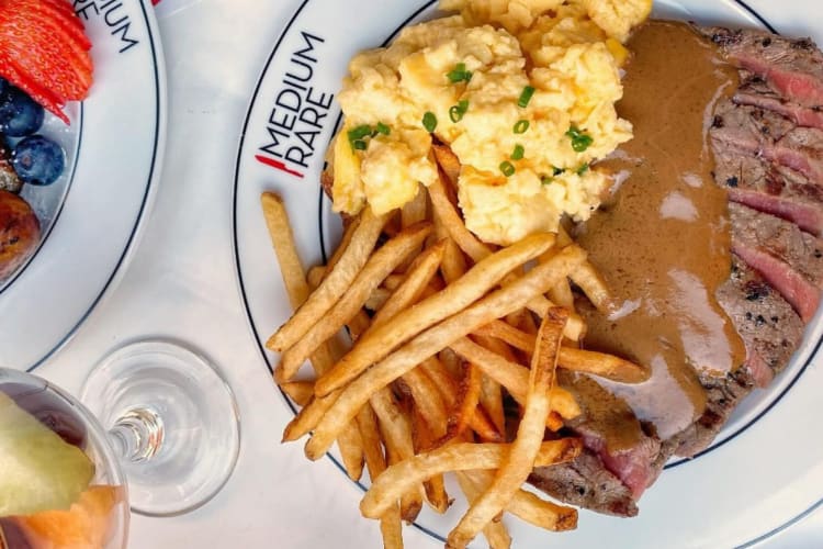 Steak and frites on a restaurant table.