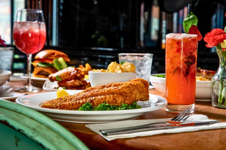 Food and cocktails on a restaurant table.