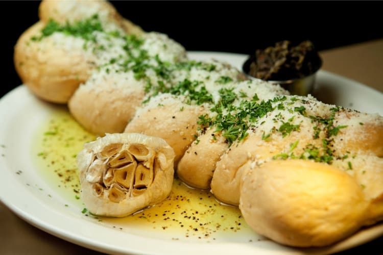 Italian bread with a full head of roasted garlic and olive oil