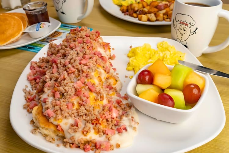 Biscuits served with crumbled sausage, ham and gravy