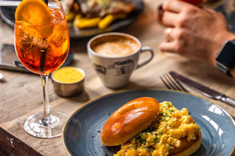 Egg bagel with an aperol spritz