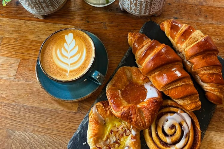 A Bath breakfast complete with a cappuccino and plate of fresh pastries