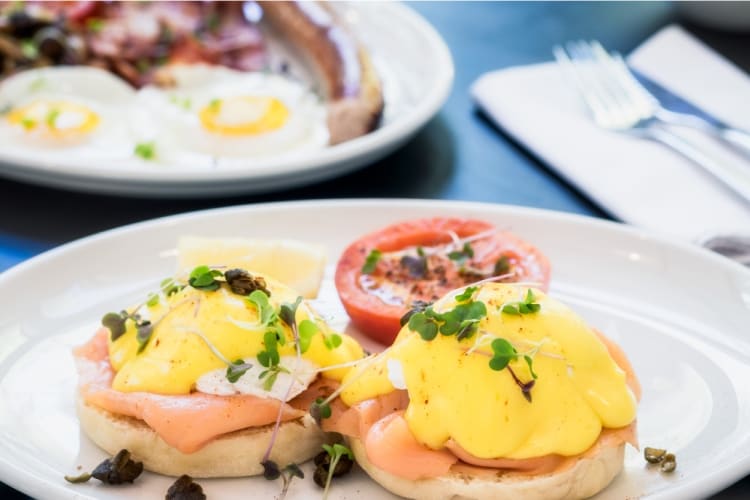 Eggs royale on a plate topped with hollandaise sauce