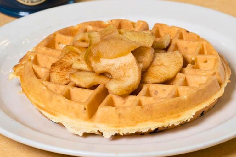 Waffles topped with sautéed cinnamon apples and cinnamon sugar