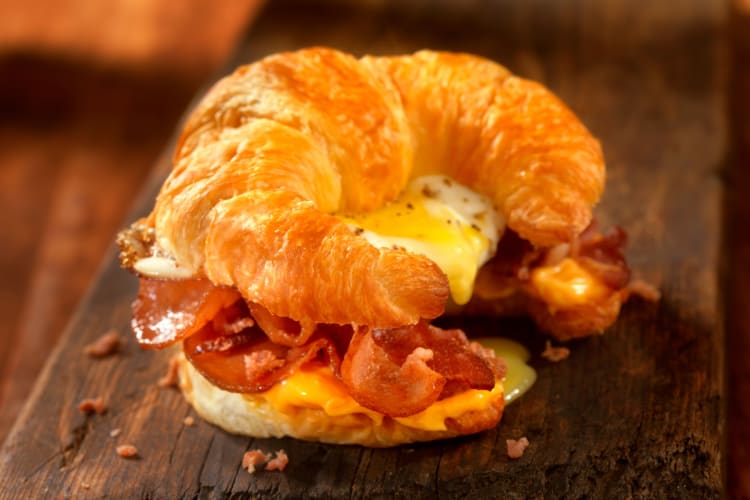 Croissant sandwich with eggs, bacon and cheese