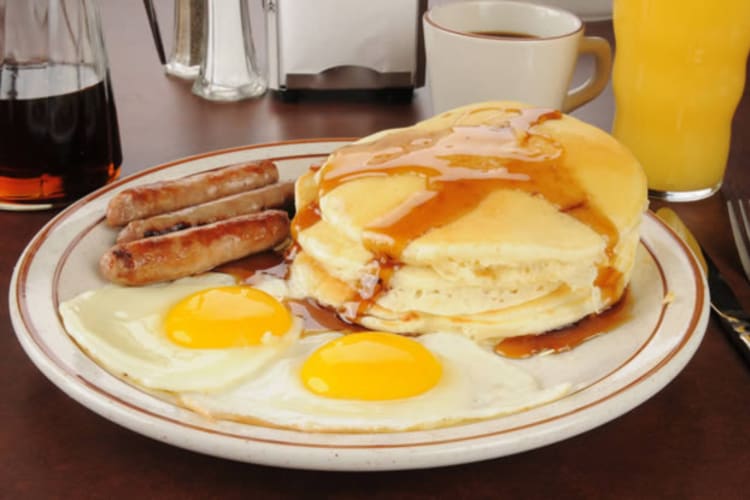 Pancakes combo served with eggs and sausage is a classic breakfast in Cleveland