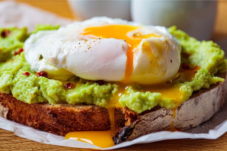 Smashed avocado on toast with poached eggs