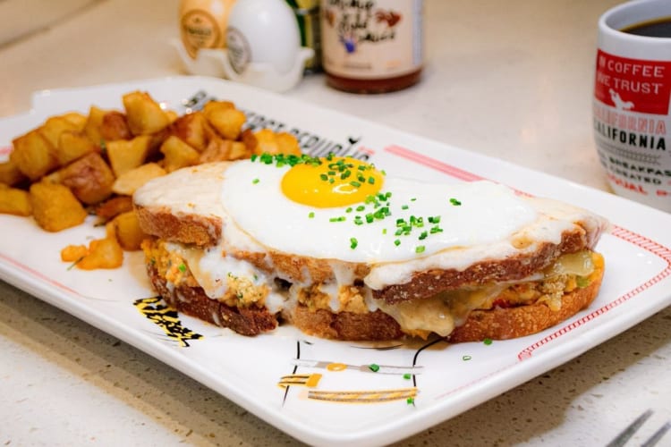 a breakfast sandwich with a fried egg on top