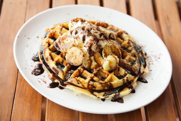 Chocolate and banana waffles on a ceramic plate