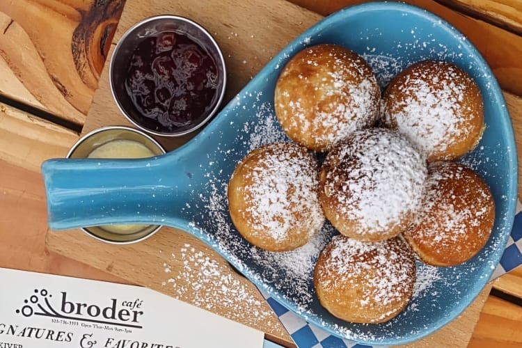 Danish pancakes topped with powered sugar and served with lemon curd and lingonberry jam