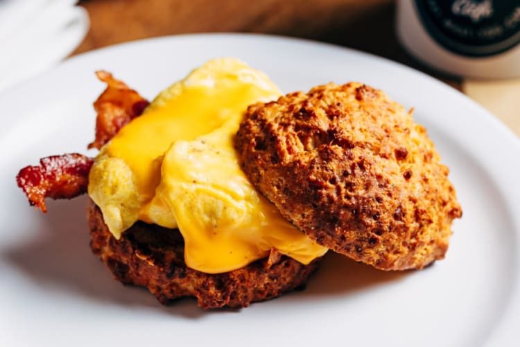 A biscuit breakfast sandwhich on a plate