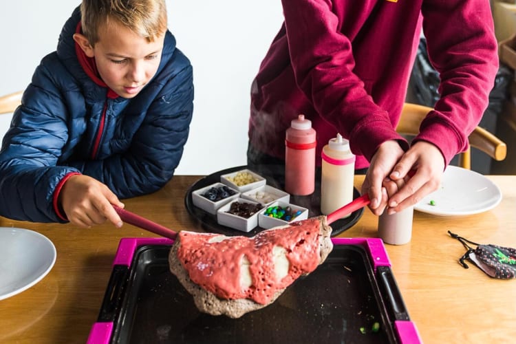 Two kids flipping a flapjack at Flap Your Jacks