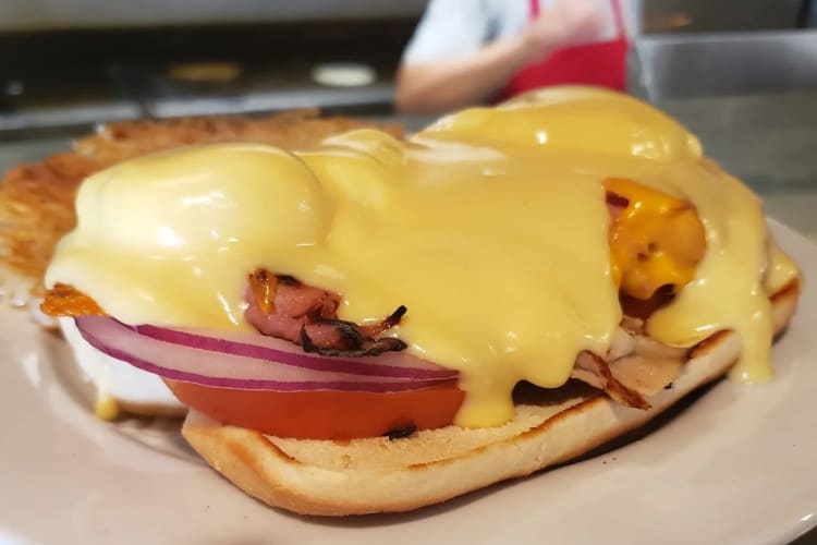 Eggs Benedict with hashbrown served on a plate