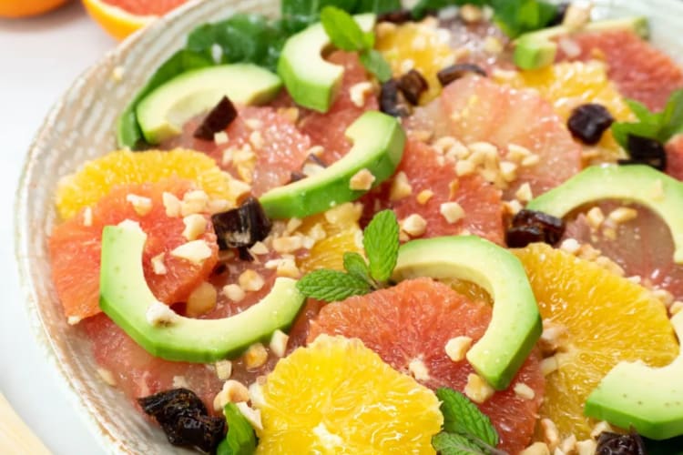 A citrus fruit salad with avocado.