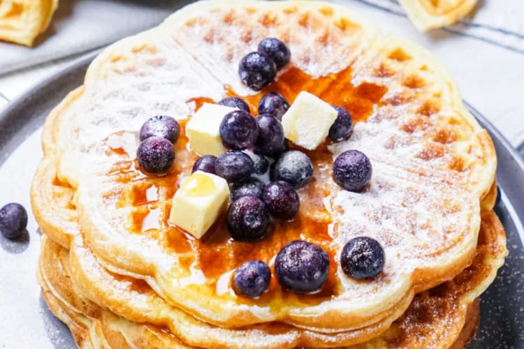 Waffles with butter and blueberries.