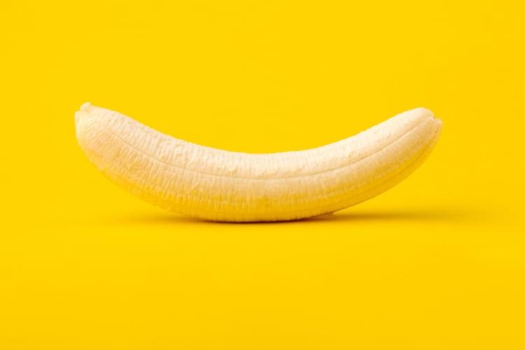 Whole banana on a yellow background