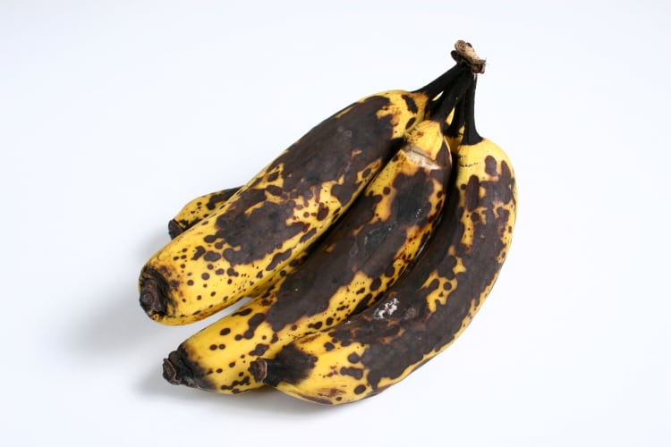 Ripe bananas on a white background