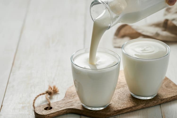 Buttermilk being poured on a cup