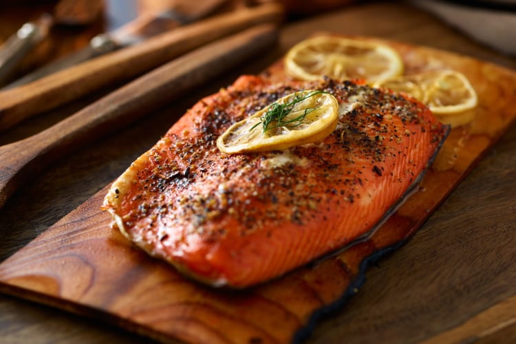 You can freeze cooked salmon by wrapping it 