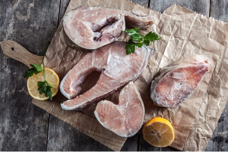 Frozen salmon on a cutting board