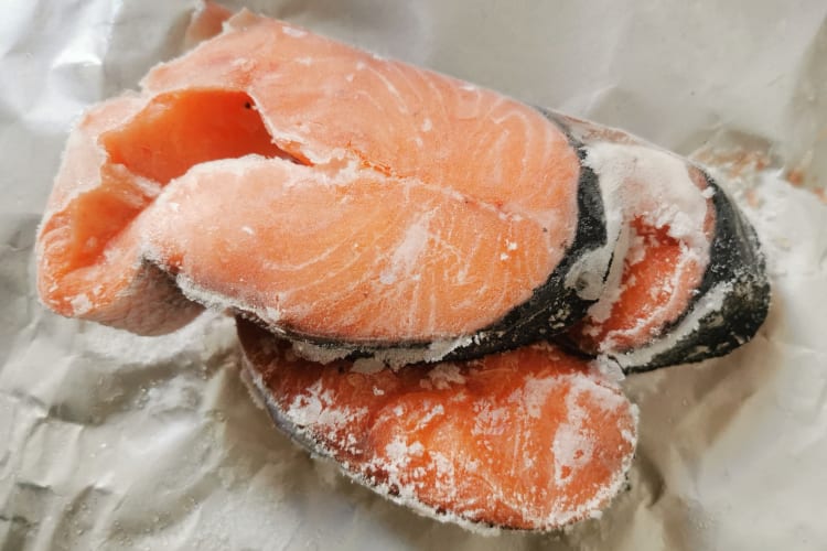 Frozen salmon on a parchement paper