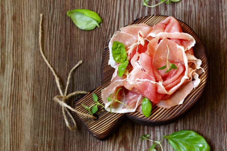 Prosciutto served on a wooden board