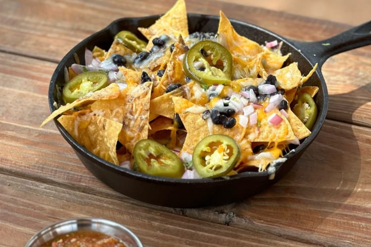 a cast-iron skillet of nachoes