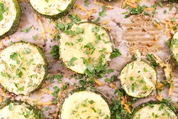 Roasted zucchini pieces on parchment paper