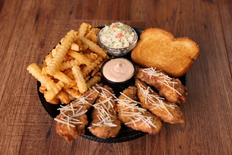 A plate of chicken tenders, fries, toast and slaw from Huey Magoo’s