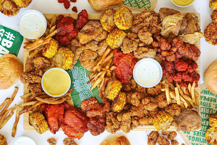 A smorgasbord of chicken, fries sauces and corn from Wingstop