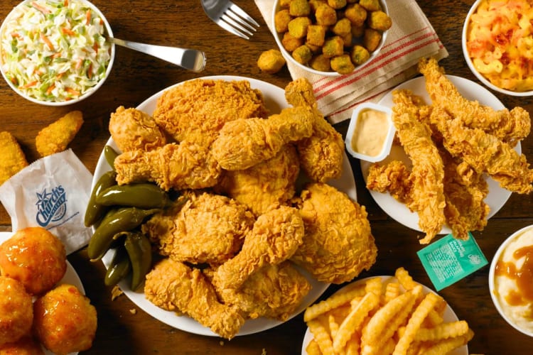 A table brimming with chicken and delicious sides from Church's Texas Chicken