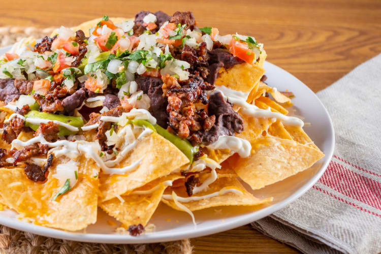 A closeup view of a plate of carne asada nachos.