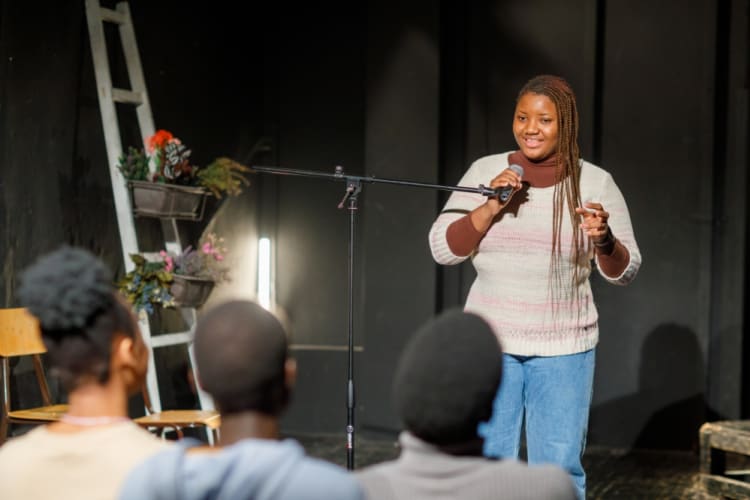 A comedian tells jokes on stage