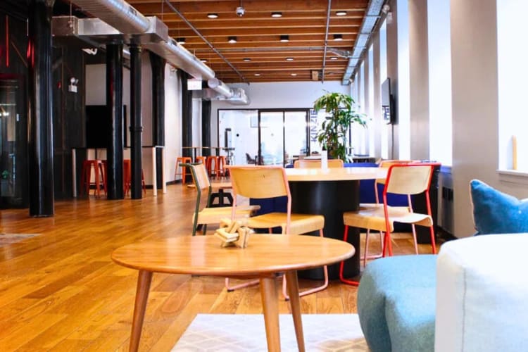 A work area with tables, chairs and couches, at Workbox – Fulton Market, a coworking space in Chicago