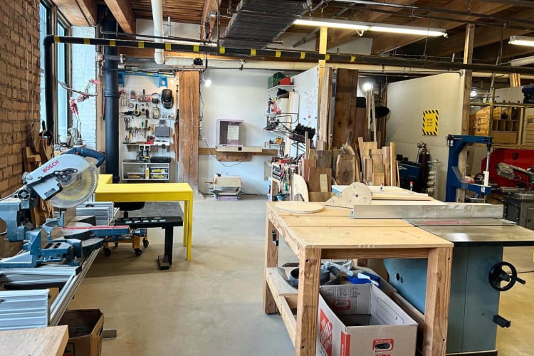 A work area with a variety of tools and workbenches, at Chicago Maker Space