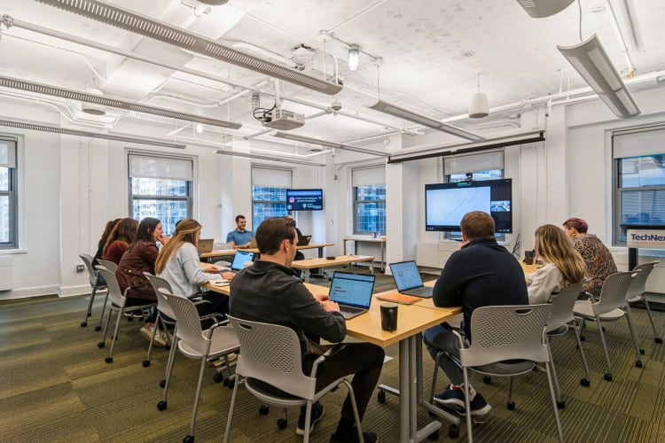 People having a meeting in a boardroom at TeamWorking by TechNexus, a coworking space in Chicago