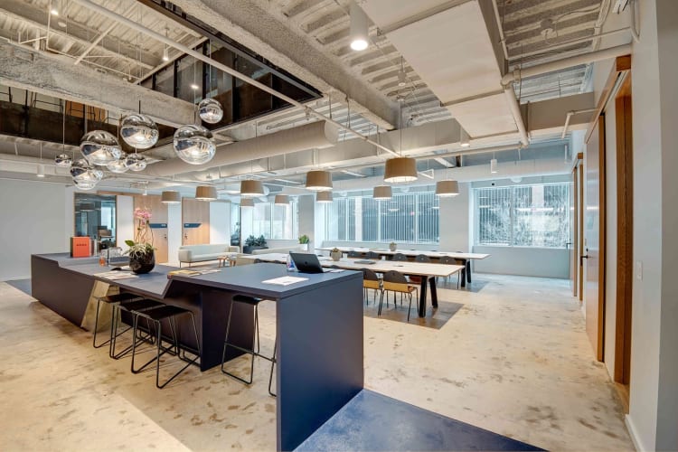 An open plan office with windows.