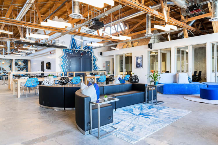 Communal area with couches, tables and chairs, at Phase Two