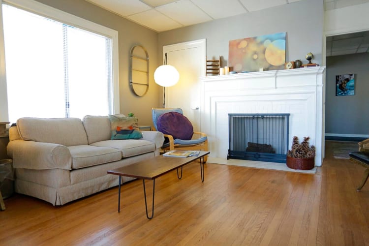 A communal area with a couch, chair and table, at Epiphany Space, a coworking space in Los Angeles