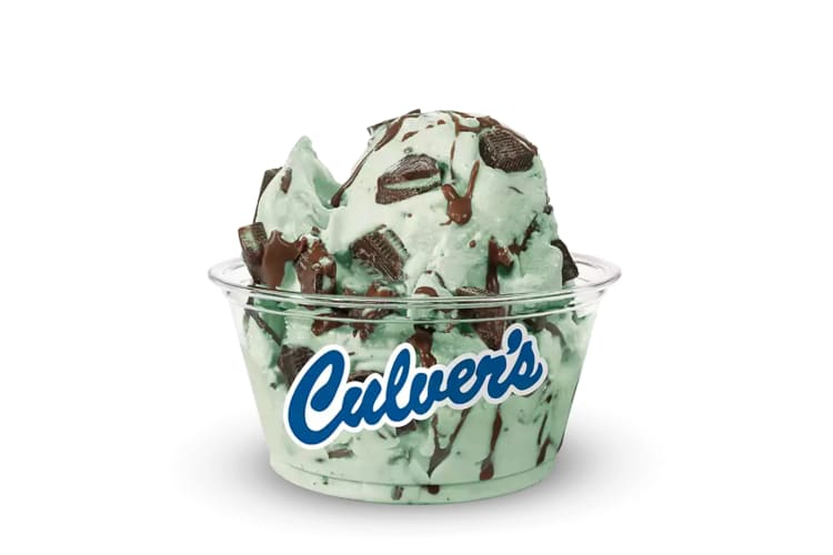 A transparent cup filled with the Andes Mint Avalanche custard flavor from Culver's