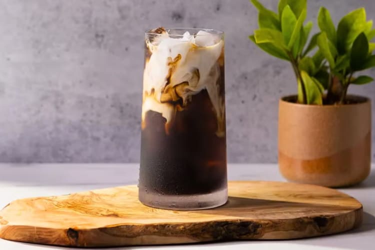 A glass of Cold Brew With Nondairy Vanilla Sweet Cream Cold Foam