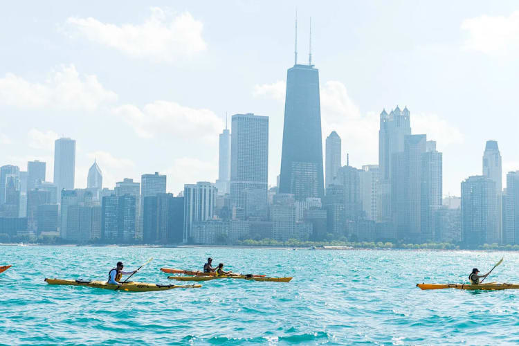 Four people kayaking along the Chicago river, a great date idea in Chicago