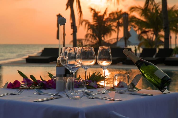 A romantic table set outdoors at sunset