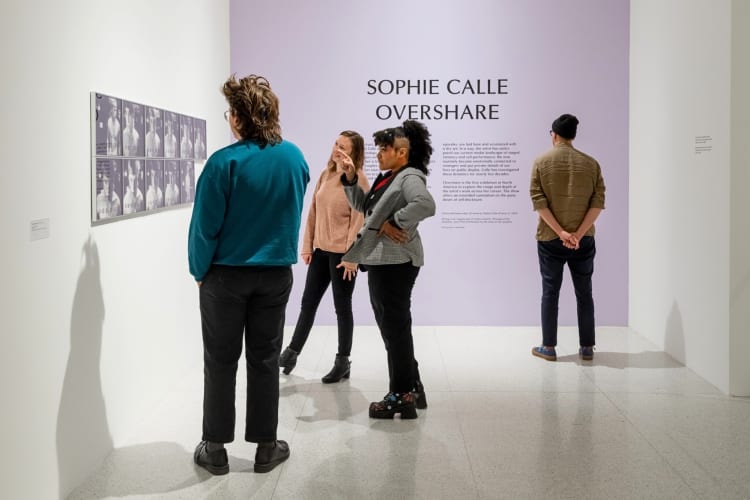 Four people looking at artworks at Walker Art Center, a great place to organize a date idea in Minneapolis