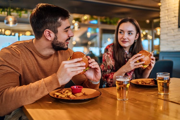 A man and woman eating at a restaurant — perfect for a date night in NYC