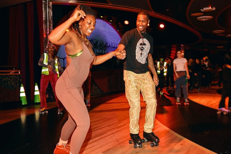 A man and woman roller skating at Xanadu Roller Arts