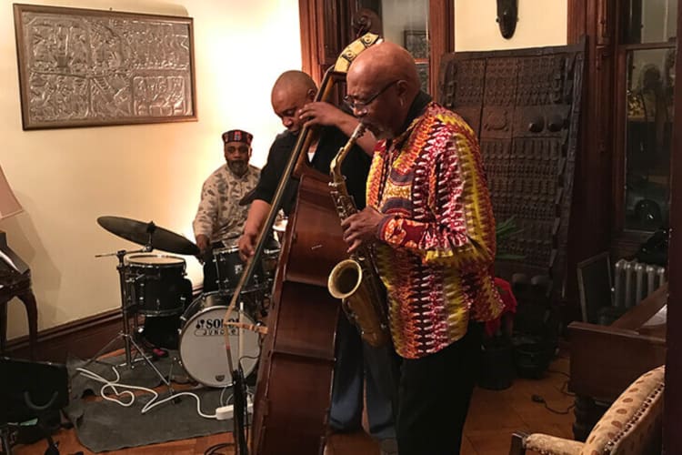 Three band members performing at the Harlem Jazz Parlor
